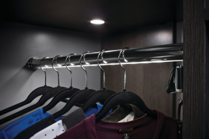 custom lighting and clothes rail in a walk in custom closet